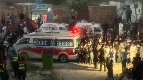An ambulance pictured at the scene of a roof collapse.