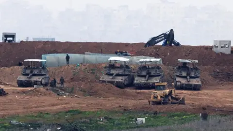 Reuters Israeli military vehicles and construction equipment in Gaza