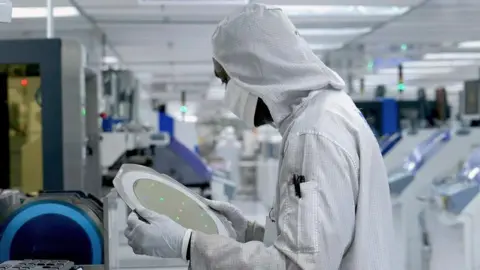 Texas Instruments A worker at a Texas Instruments plant in Malaysia.