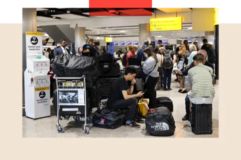 Reuters Travellers wait near the British Airways check-in area at Heathrow Airport, as Nats restricts UK air traffic due to a technical issue causing delays