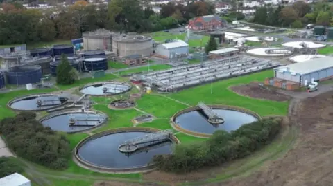 A huge treatment plant. There are a number of large circular dams and factories and other buildings. 