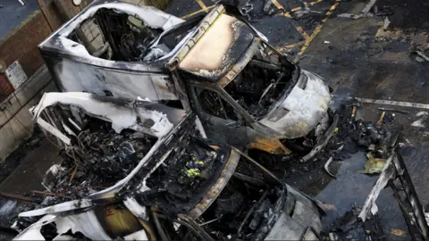 Charred remains of ambulances belonging to Hatzola, a Jewish community organisation, which were set on fire in an incident that the police say is being treated as an antisemitic hate crime, in northwest London, Britain, March 23, 2026.