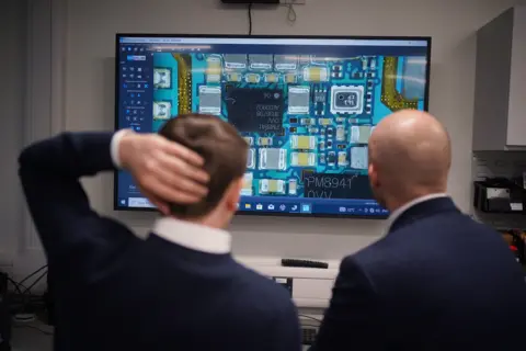 PA Media People looking at screen