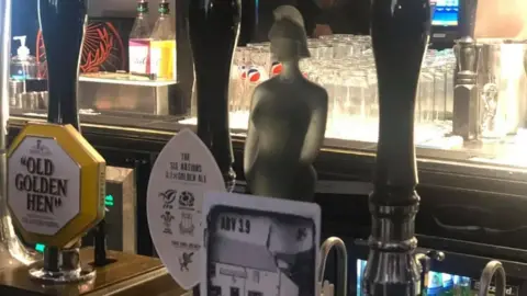 Low Lights Tavern The pub's bar which has a pump for Old Golden Hen. The middle pump is Sam Fender's silver Brit award statue which has been turned into a beer pump.