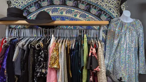 Supplied A clothes rail with a range of sequinned and glittery tops.