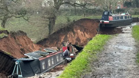 Shropshire Fire and Rescue Service Two canal barges at the scene of a sinkhole.