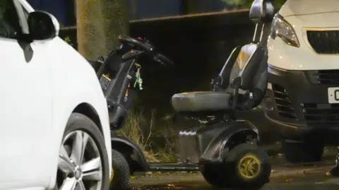 PA Media A black and grey mobility scooter was pictured at the crime scene on Wednesday evening