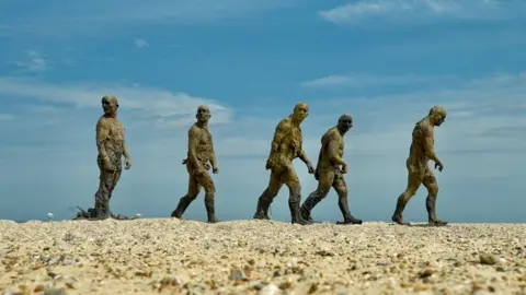 Jamie Niblock/BBC Five statues of men in different poses as if walking