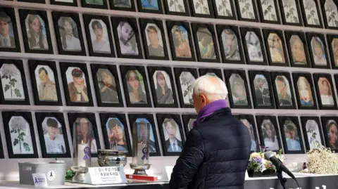 Reuters A man mourns at the memorial altar for victims before a press conference against the government’s decision to veto a special bill for the Itaewon disaster that killed over 150 people in the party district of Itaewon, in Seoul, South Korea, January 30, 2024. 