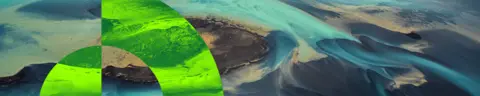 Thin banner with an image of sand dunes overlaid with a bright green circular pattern aligned to the left.