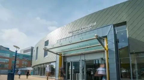 Getty Images An image of Southampton Airport - it's a big building with yellow welcome shelter. Big windows on the outside. It's a sunny day with blue sky.