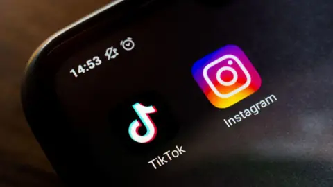 Getty Images TikTok and Instagram apps displayed on a smartphone screen