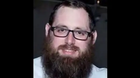 StandWithUs Rabbi Yaakov Levitan in white shirt wearing black glasses