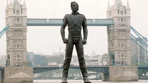 A giant Michael Jackson statue appears to be stood on the River Thames in front of Tower Bridge.