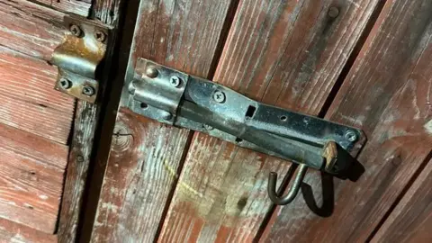  The Wrestlers A broken lock on a fence