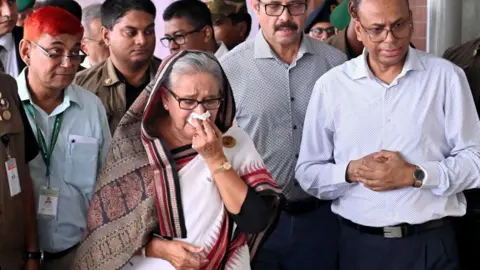 Getty Images Sheikh Hasina was photographed crying over a metro station destroyed during anti-government protests