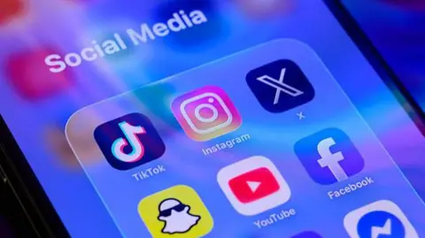 Getty Images The app symbols for Snapchat, YouTube, Facebook, TikTok, Instagram and X are displayed on a smartphone screen, under the label Social Media.