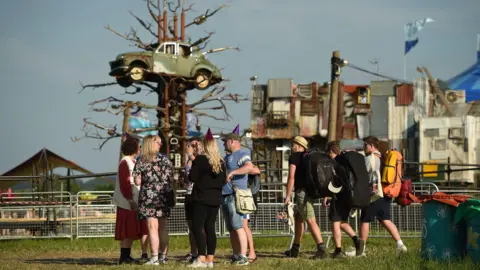 Getty Crowd stood in front of car sculpture 