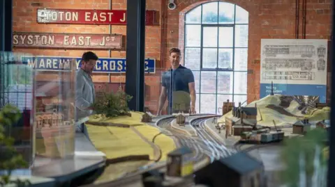 Derby Museums Model railway with two men stood in background.