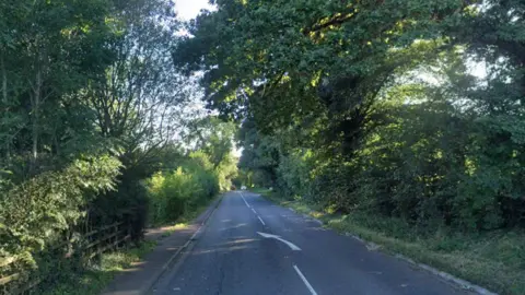 Google maps image of the A46 country road. An arrow can be seen in the middle of the road pointing slightly left.