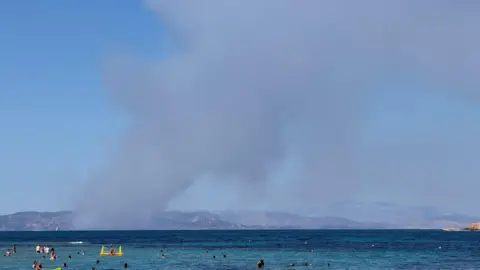 Smoke rises in Salamina during wildfire as seen from Agistri island