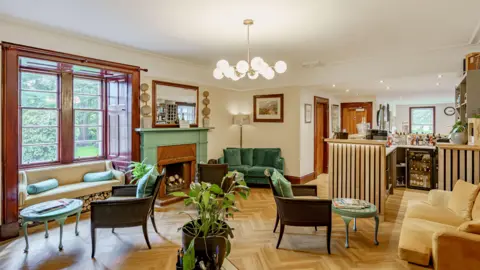 Fine & Country Scotland A bar area in a hotel with comfortable seating and potted plants