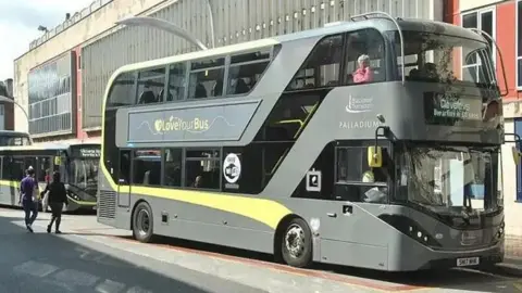Grey and yellow double decker Blackpool Transport bus parked at a bus stop on Market Street, Blackpool.