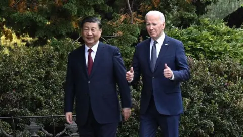 Getty Images US President Joe Biden (R) and Chinese President Xi Jinping walk together after a meeting during the Asia-Pacific Economic Cooperation (APEC) 