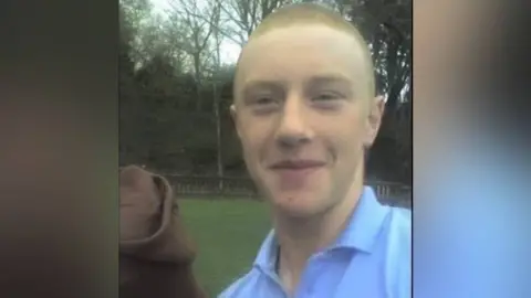 Maxine Johnson Reuben Morgan, who has short hair and is wearing a blue polo shirt
