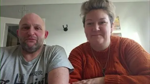 Debt-stricken calls surge - however here is how one can cope Paul and Sam Helsby sit in a room with pictures and a coat hook behind them
