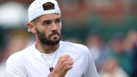 Jacob Fearnley clenches his fist during his first-round win at Wimbledon