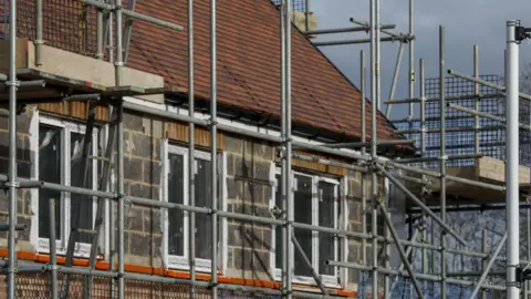 Scaffolding surrounds housing development near Guildford. 