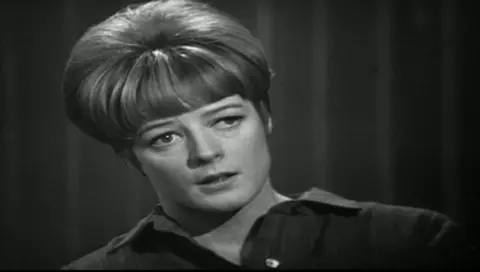 Maggie Smith staring off camera towards an interviewer in a black and white interview with the BBC