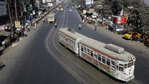 AFP A tram rolls along a main road which is usually jammed with traffic, during a 12-hour general strike in Kolkata on January 22, 2009. 