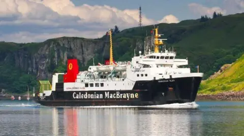 MV Hebridean Isles ferry sailing with cliffs and hills in the background