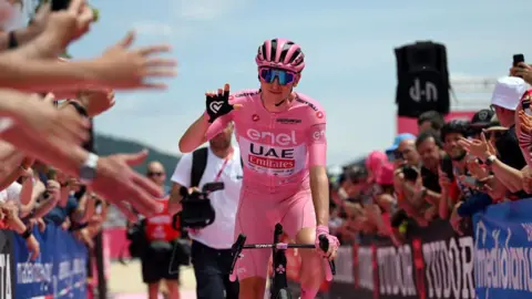 Tadej Pogacar celebrates victory in the stage seven time trial at the Giro d'Italia