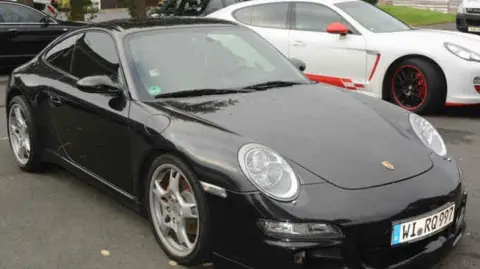 West Yorkshire Police A black Porsche Carrera parked in a car park