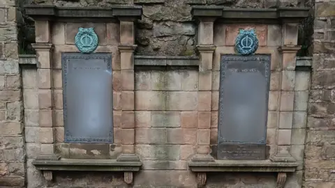Mrs Pauline Smith A war memorial containing graffiti that has been blurred for the viewer