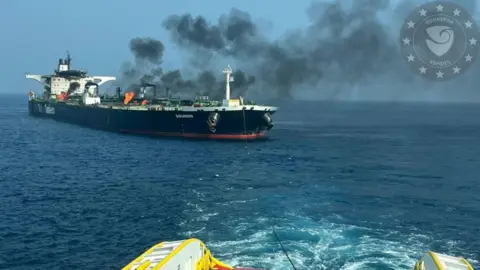 Photo released by EU Naval Force showing a tug pulling the burning oil tanker Sounion in the Red Sea on 14 September 2024