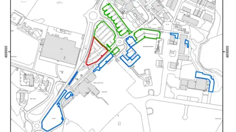 IOM GOV A map of Ronaldsway thhat outlines the parking areas. On the left of the site and right of the airport are blue areas, which designates private parking, a smaller red area is in front of the building and a larger green area is diagonally right.