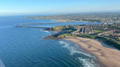 Geoff Cowan An aerial view of Longsands beach with houses on the clifftop