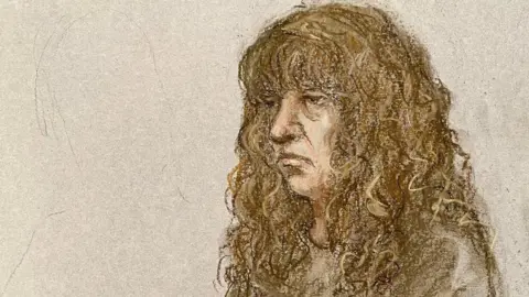 Elizabeth Cook via PA Court sketch of defendant in dock wearing a brown tracksuit. She has long straggly brown hair and looks unhappy.