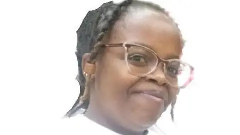 Rose Njeri, in glasses and white T-shirt