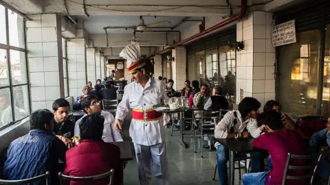 AFP A waiter serves customers at the India Coffee House in New Delhi, India, on Thursday, Dec. 5, 2013.