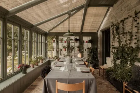 Fran Mart for Wildland Kinloch Lodge - a restored interior of a conservatory/dining room