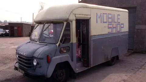 Pacemaker An old looking blue and white van with mobile shop on the side parked in a walled area. The van was the scene of a triple murder in 1991.