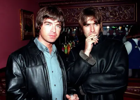 LONDON - 1995: Oasis lead singer Liam Gallagher and brother Noal Gallagher at the opening night of Steve Coogan's comedy show in the West End, London.
