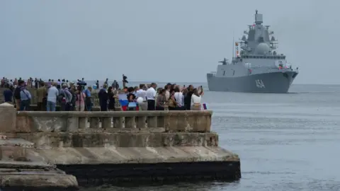 Reuters People watch Russia's frigate Admiral Gorshkov as it enters the Havana Bay, Cuba. Photo: 12 June 2024