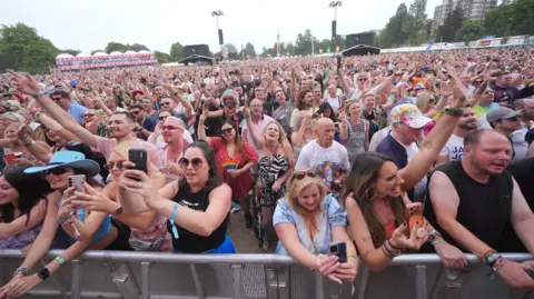 PA Media The crowd watching boyband Five on stage during Pride on the Park 2026, at Preston Park in Brighton, East Sussex