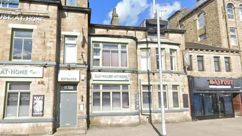 Google The front of a pub, pictured in sunshine. The pub has lots of windows across its two storeys and pistachio green name signs are placed above two of the ground floor windows. There is a lamp-post on the pavement outside.